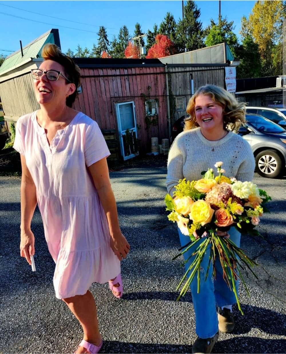 Robin and a student holding flowers at Vancouver Flower School